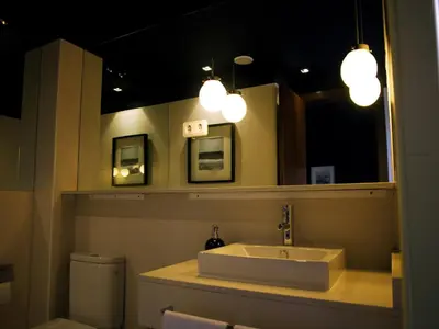 a bathroom with a sink and a mirror and lights at Hostal Badaloní in Badalona