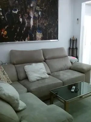 a living room with a couch and a table at Piso luminoso en Barcelona in Barcelona