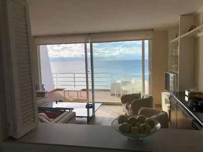 a kitchen and living room with a view of the ocean at Llevant - Vistas espectaculares in San Pol de Mar
