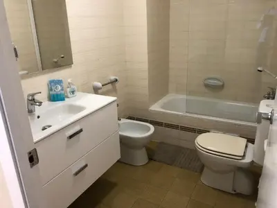 a bathroom with a sink and a toilet and a tub at Llevant - Vistas espectaculares in San Pol de Mar