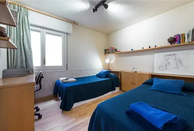 a bedroom with two beds and a window at Llevant - Vistas espectaculares in San Pol de Mar