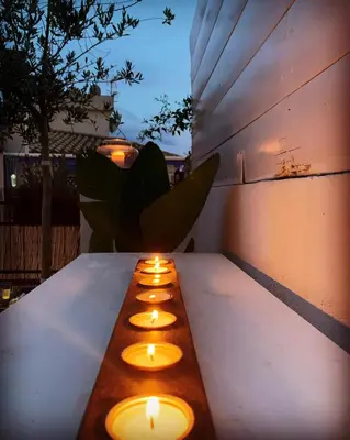 a row of candles sitting on top of a table at Penthouse Sitges in Sitges