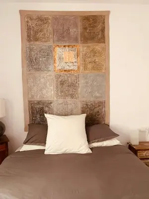 a bedroom with a bed with a brick wall at Penthouse Sitges in Sitges