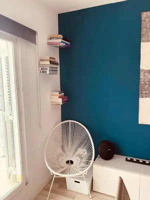a white fan in a room with a blue wall at Penthouse Sitges in Sitges