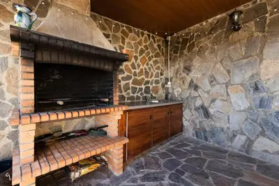a fireplace in a room with a stone wall at Casa Lourdes in Canyelles
