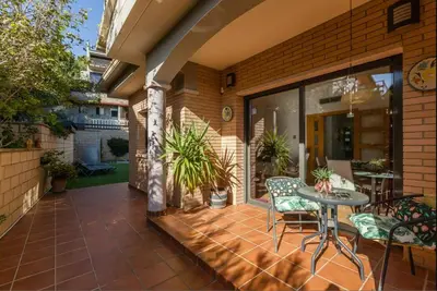 a patio with a table and chairs on a house at Casa Lourdes in Canyelles