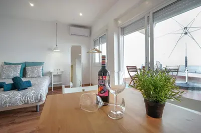 a bottle of wine on a table in a living room at Hotelito Boutique Cinca in Hospitalet de Llobregat