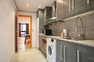 a kitchen with a washing machine and a sink at Alcam Alio 2 in Barcelona
