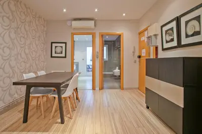 a dining room with a table and chairs and a bathroom at Alcam Alio 2 in Barcelona