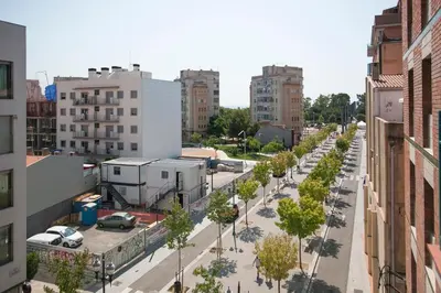 an empty street in a city with buildings at Tendency Rambla del Poblenou in Barcelona