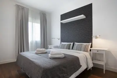 a bedroom with a large bed with two towels on it at Tendency Rambla del Poblenou in Barcelona