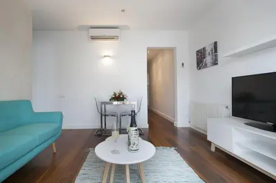 a living room with a couch and a table at Tendency Rambla del Poblenou in Barcelona
