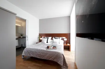 a bedroom with a bed with two teddy bears on it at Serennia Apartamentos Ramblas - Plaça Catalunya in Barcelona