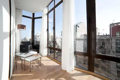 an office with a view of the city from a balcony at Serennia Apartamentos Ramblas - Plaça Catalunya in Barcelona