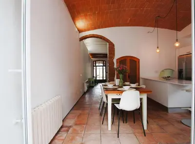 a kitchen and dining room with a table and chairs at The Painter's Home in Vilassar de Mar