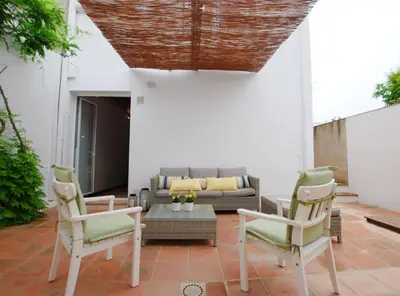 a patio with two chairs and a couch at The Painter's Home in Vilassar de Mar