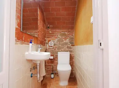 a bathroom with a toilet and a sink at The Painter's Home in Vilassar de Mar