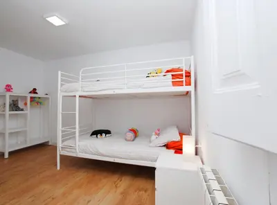 a white bunk bed in a white room with a cat on it at The Painter's Home in Vilassar de Mar