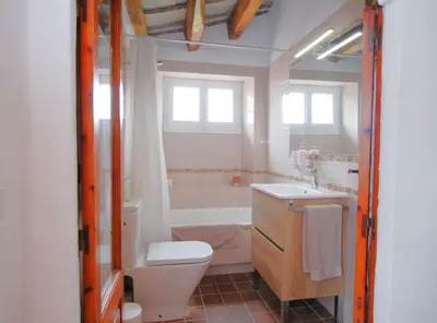 a bathroom with a toilet and a sink and a tub at The Painter's Home in Vilassar de Mar