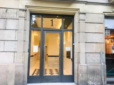 a glass door of a building with the number one on it at Casa Vaganto in Barcelona