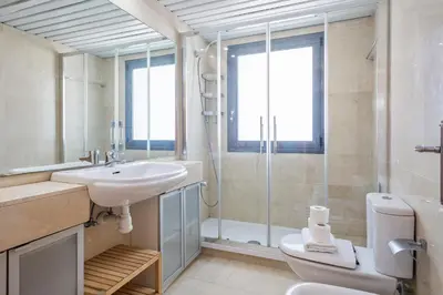 a bathroom with a sink and a toilet and a shower at Alcam Badalona Playa Norte in Badalona