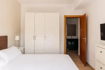 a dining room with a table and white chairs at Barcelona Apartment Gran de Gràcia in Barcelona