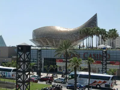 a large building with a large building with a pyramid at Apartamentos City Beach in Barcelona