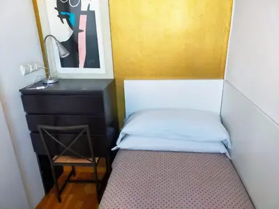 a bed in a room with a desk and a chair at Barceloneta Port Ramblas in Barcelona
