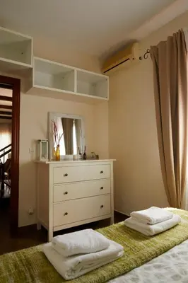 a bedroom with a bed with a dresser and a mirror at Amazing Vila close to Sitges, jacuzzi, swimming pool & exellent views in Olivella