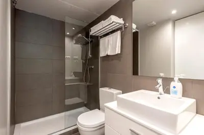 a bathroom with a sink and a toilet and a mirror at Espais Blaus Apartments in Barcelona