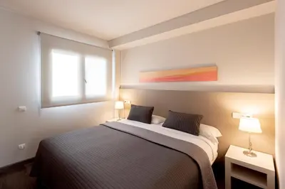 a bedroom with a bed and a window at Espais Blaus Apartments in Barcelona