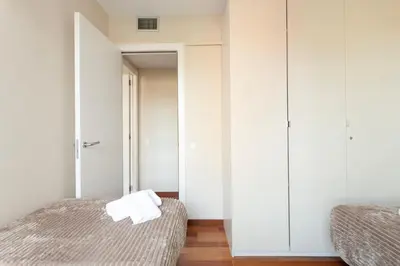 a bedroom with two beds and a closet at 4131 - AB Diagonal - Sant Adrià de Besòs in Sant Adria de Besos