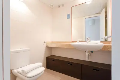 a bathroom with a sink and a toilet and a mirror at 4131 - AB Diagonal - Sant Adrià de Besòs in Sant Adria de Besos