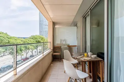 a balcony with a table and chairs and a window at 4131 - AB Diagonal - Sant Adrià de Besòs in Sant Adria de Besos