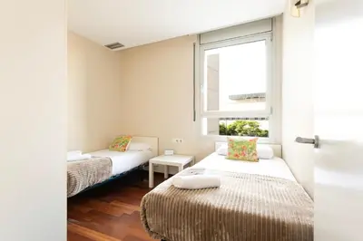 a small room with two beds and a window at 4131 - AB Diagonal - Sant Adrià de Besòs in Sant Adria de Besos