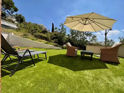 a patio with a table and chairs and an umbrella at Sono & SPA - Adults Only in La Garriga