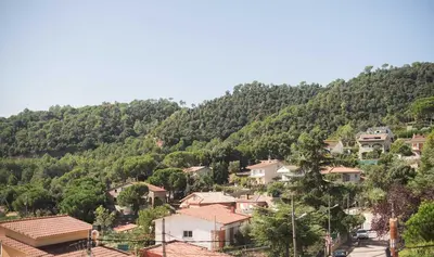 a village on a hill with houses and trees at Sono & SPA - Adults Only in La Garriga