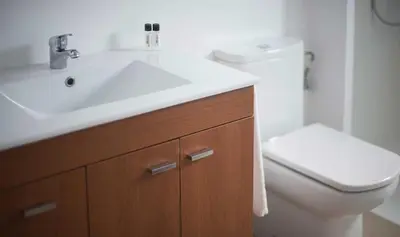 a bathroom with a white sink and a toilet at Sono & SPA - Adults Only in La Garriga