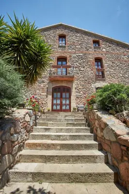 a living room with a clock on the wall at Mas Can Calet Aparthotel in Les Franqueses del Vallès