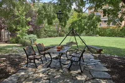 a patio with a table and chairs in a yard at Mas Can Calet Aparthotel in Les Franqueses del Vallès