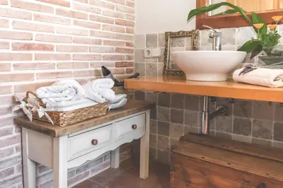 a bathroom with a sink and a counter with towels at Can Caponet in Lliçà d'Amunt
