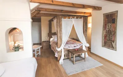 a bedroom with a bed and a canopy bed in it at Can Caponet in Lliçà d'Amunt
