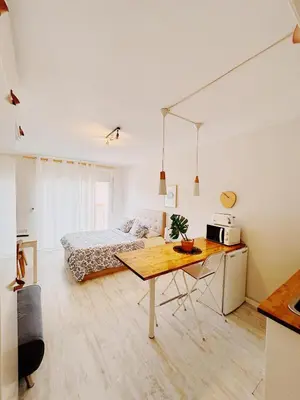 a bedroom with a bed and a table in a room at Tropical Apartaments Euroviajeros in Pineda de Mar