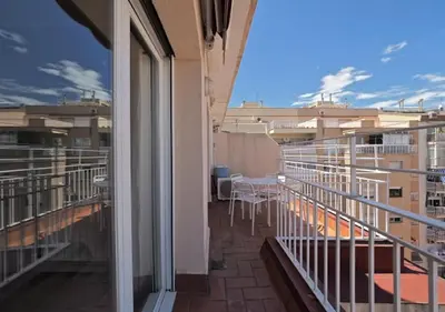 a balcony with tables and chairs on a building at Sagrada Penthouse in Barcelona