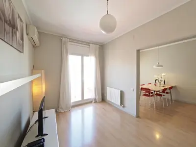 a living room with a table and a dining room at Sagrada Penthouse in Barcelona