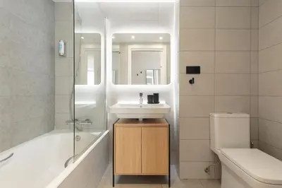 a bathroom with a sink and a tub and a toilet at Port Forum Apartments by Olala Homes in Sant Adria de Besos