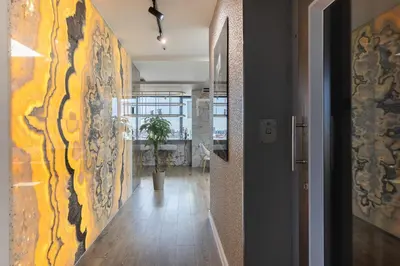 a hallway with a wall with paintings on it at Cosmo Suite Penthouse in Barcelona