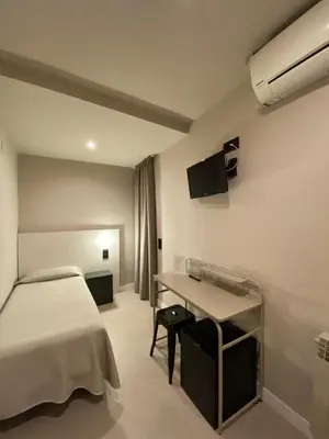 a bathroom with a tub and a toilet and a shower at Pensión Coral in Barcelona