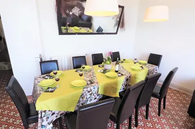 a dining room with a long table with black chairs at MARISOL SEAVIEW & BEACH - apartment in Masnou