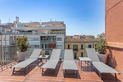 a row of white benches on a balcony at My Space Barcelona Pool City Center in Barcelona